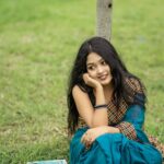 woman-sits-grass-with-her-hand-her-chin_1121250-517612