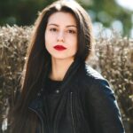 young-beautiful-girl-posing-black-leather-jacket-park_1153-8104-1